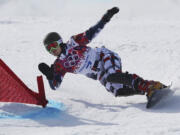 Russia's Vic Wild, a native of White Salmon, Wash., competes on the way to winning the men's snowboard parallel giant slalom semifinal at the Rosa Khutor Extreme Park on  Wednesday in Krasnaya Polyana, Russia.