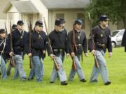 1st Oregon Volunteer Infantry re-enactors march in formation during a soldiers bivouac demonstration at the Vancouver Barracks on May 27, 2013.