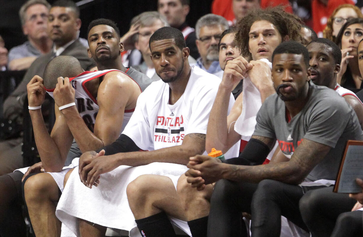 From left, Portland Trail Blazers' Nicolas Batum, Dorell Wright, LaMarcus Aldridge, Robin Lopez, Thomas Robinson and Wesley Matthews watch from the bench in the final minute of their Game 3 loss to San Antonio.