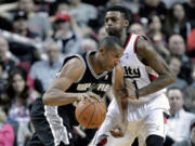 San Antonio Spurs center Boris Diaw, from France, left, drives on Portland forward Dorell Wright during the first half Wednesday.