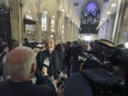 Timothy Cardinal Dolan, Archbishop of New York, speaks to reporters after a ceremony in which galeros, or cardinal's hats, were once again hung from the cathedral ceiling Aug. 25 at St. Patrick's Cathedral in New York. The renovation, done in three phases over three years, started in 2012 and is slated to be finished before the Pope's visit in September 2015.