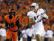 Stanford&#039;s Austin Hooper, right, catches a touchdown pass as Oregon State&#039;s Larry Scott trails during the first half Friday in Corvallis, Ore. (Timothy J.