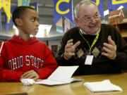 Isaiah Ephraim, then a fifth-grader at Martin Luther King Elementary School in Vancouver, listens as Steve Runyan, a volunteer Lunch Buddy, talks about Patrick McManus' story &quot;Blood Sausage&quot; in February 2008. The two had been lunch buddies since Isaiah was in third grade.