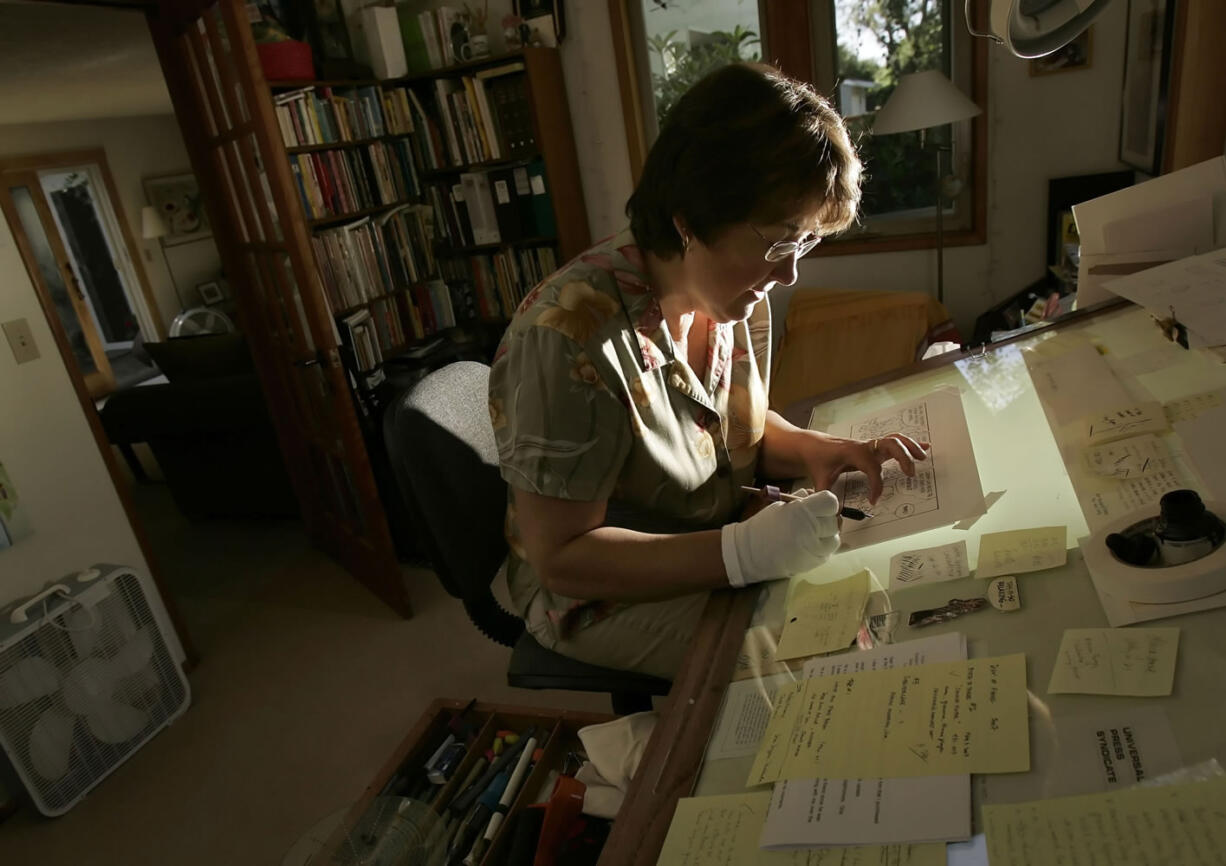 In this July 27, 2015, photo, cartoonist Jan Eliot works on her comic strip &quot;Stone Soup&quot; in her Eugene, Ore. Before achieving syndication fame, Eliot was a single mom &oacute; a staple theme of the comic strip &oacute; working full-time, raising two daughters and trying to get off the ground a comic strip that resonated with people who understand that situation.