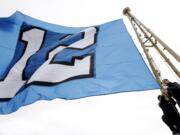 Workers re-set the &quot;12th Man&quot; flag, honoring Seattle Seahawks fans, after it was raised atop the Space Needle on Wednesday in Seattle.