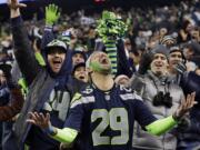 Seattle Seahawks fans celebrate a Seahawks touchdown run by Marshawn Lynch during the second half of the NFC championship game last Sunday.