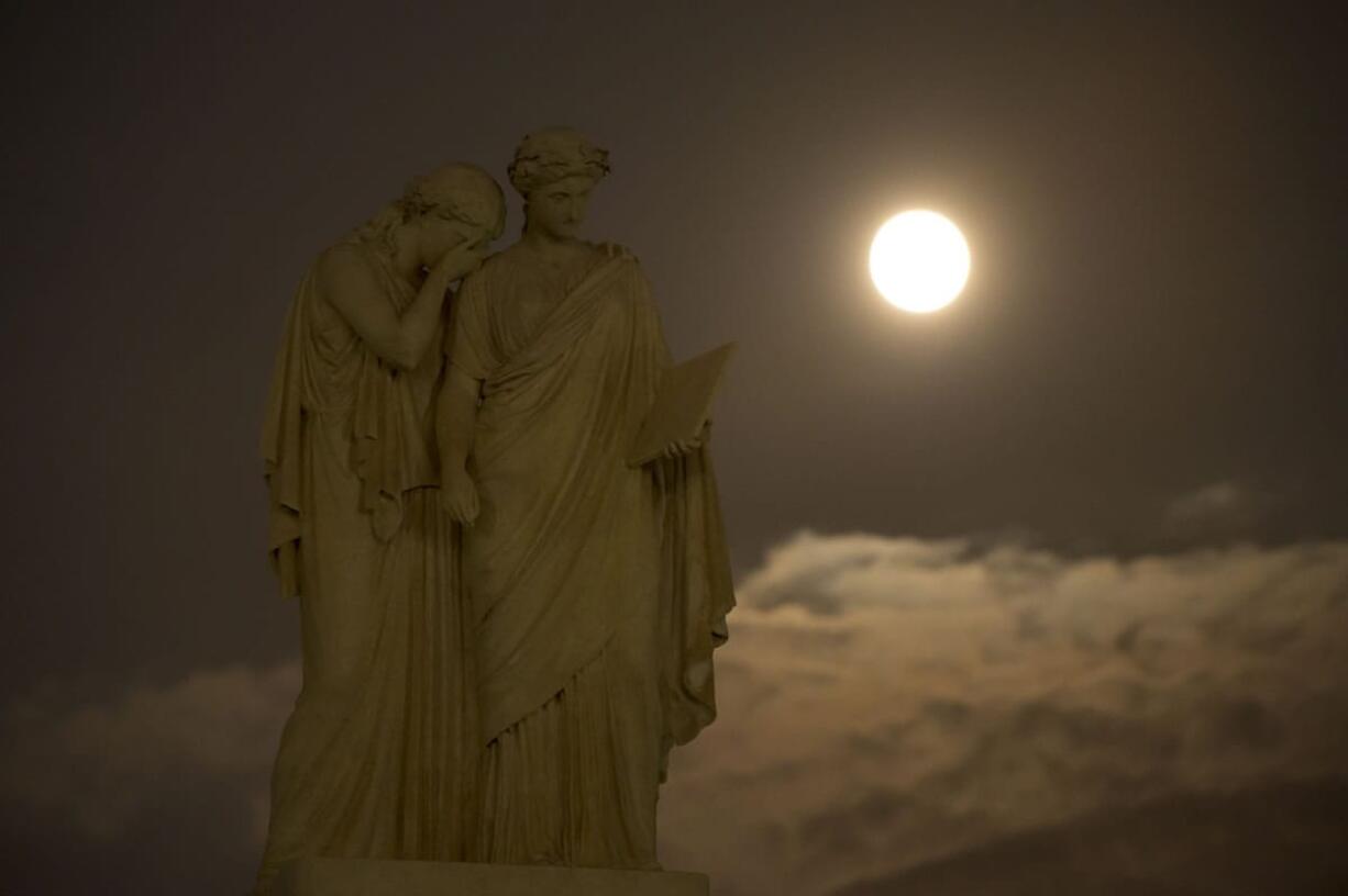 In this photo provided by NASA, a perigee full moon or supermoon is seen over the the Peace Monument on the grounds of the United States Capitol, Sunday, Aug. 10, 2014, in Washington.