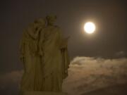 In this photo provided by NASA, a perigee full moon or supermoon is seen over the the Peace Monument on the grounds of the United States Capitol, Sunday, Aug. 10, 2014, in Washington.