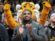 Missouri's All-American defensive end Michael Sam claps during the Cotton Bowl trophy presentation at halftime of an NCAA college basketball game between Missouri and Tennessee, Saturday, Feb. 15, 2014, in Columbia, Mo. Sam came out to the entire country Sunday, Feb. 9, and could become the first openly gay player in the NFL. (AP Photo/L.G.