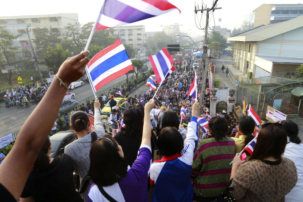 Anti-government protesters make their way down a street Sunday during a rally opposing an advance voting in Bangkok, Thailand.