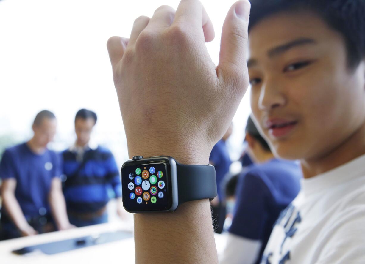 A customer tries on an Apple Watch on April 10 at an Apple Store in Hong Kong.