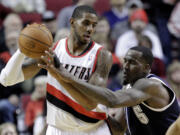 Oklahoma City Thunder center Kendrick Perkins, right, reaches in on Portland Trail Blazers forward LaMarcus Aldridge during the first half of an NBA basketball game in Portland, Ore., Tuesday, Feb. 11, 2014.