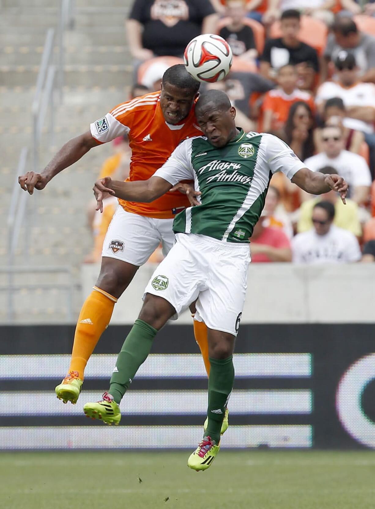 Houston Dynamo defender Jermaine Taylor and Portland Timbers' Darlington Nagbe (6) fight to head the ball. Nagbe continues to be the most-fouled player in MLS, with 29 infractions cited against him. (AP Photo/Houston Chronicle, Thomas B.