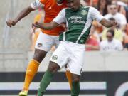 Houston Dynamo defender Jermaine Taylor and Portland Timbers' Darlington Nagbe (6) fight to head the ball. Nagbe continues to be the most-fouled player in MLS, with 29 infractions cited against him. (AP Photo/Houston Chronicle, Thomas B.