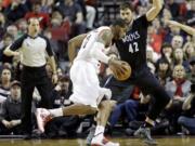 Portland Trail Blazers forward LaMarcus Aldridge, left, drives on Minnesota Timberwolves forward Kevin Love during the first half Saturday.