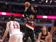 Portland Trail Blazers guard Mo Williams (25) shoots over Chicago Bulls center Joakim Noah (13) as Robin Lopez watches during the second half of an NBA basketball game Friday, March 28, 2014, in Chicago. The Trail Blazers won 91-74.