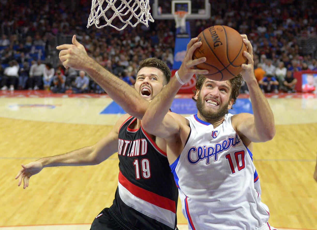 Portland Trail Blazers center Joel Freeland, left, has improved his defense and field goal percentage this season.