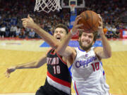 Portland Trail Blazers center Joel Freeland, left, has improved his defense and field goal percentage this season.