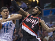 Orlando's Tobias Harris (12) fights for a defensive rebound with Portland's Will Barton (5) during the second half Tuesday.