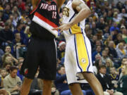 Portland's LaMarcus Aldridge, left, shoots over Indiana's David West in the first half Saturday, Dec. 13, 2014. Portland won 95-85.