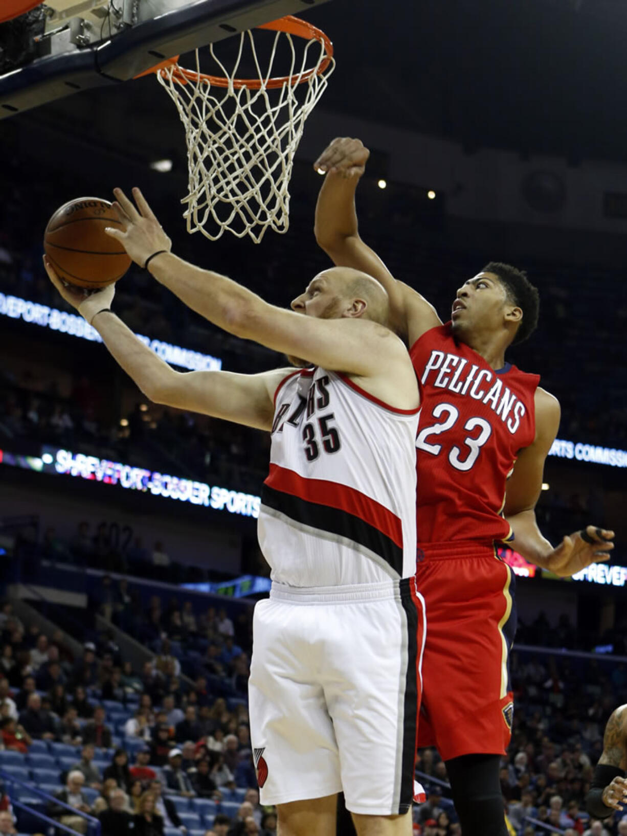 Portland's Chris Kaman (35) shoots around New Orleans' Anthony Davis (23) in the first half Saturday, Dec. 20, 2014, in New Orleans, La.