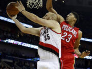 Portland's Chris Kaman (35) shoots around New Orleans' Anthony Davis (23) in the first half Saturday, Dec. 20, 2014, in New Orleans, La.