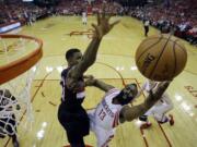 Houston Rockets' James Harden (13) put sup a shot against Portland Trail Blazers' Thomas Robinson (41) during the first half in Game 2 of an opening-round NBA basketball playoff series Wednesday, April 23, 2014, in Houston. (AP Photo/David J.