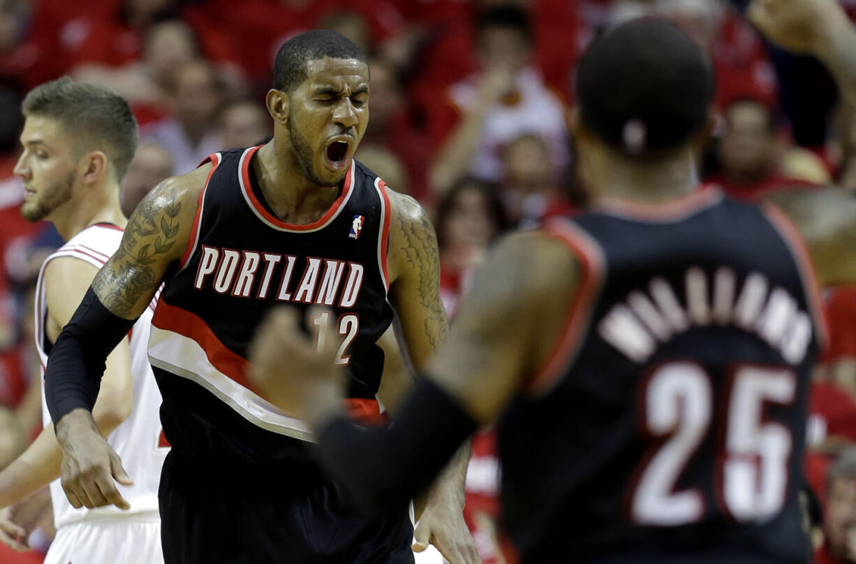 Portland Trail Blazers' LaMarcus Aldridge (12) reacts after making a basket while being fouled during the fourth quarter in Game 1 of an opening-round NBA basketball playoff series against the Houston Rockets  Sunday, April 20, 2014, in Houston. The Trail Blazers won 122-120 in overtime. (AP Photo/David J.