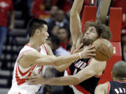 Houston Rockets' Jeremy Lin, left, tries to pass the ball around Robin Lopez in the first half Wednesday.