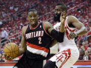 Portland Trail Blazers' Wesley Matthews (2) tries to drive past Houston Rockets' James Harden during the first half in Game 1 of an opening-round NBA basketball playoff series Sunday in Houston.