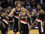 Portland Trail Blazers' Damian Lillard (0) and teammates wait to enter the game following a timeout during the first half of Game 1 of a Western Conference semifinal NBA basketball playoff series against the San Antonio Spurs, Tuesday, May 6, 2014, in San Antonio.