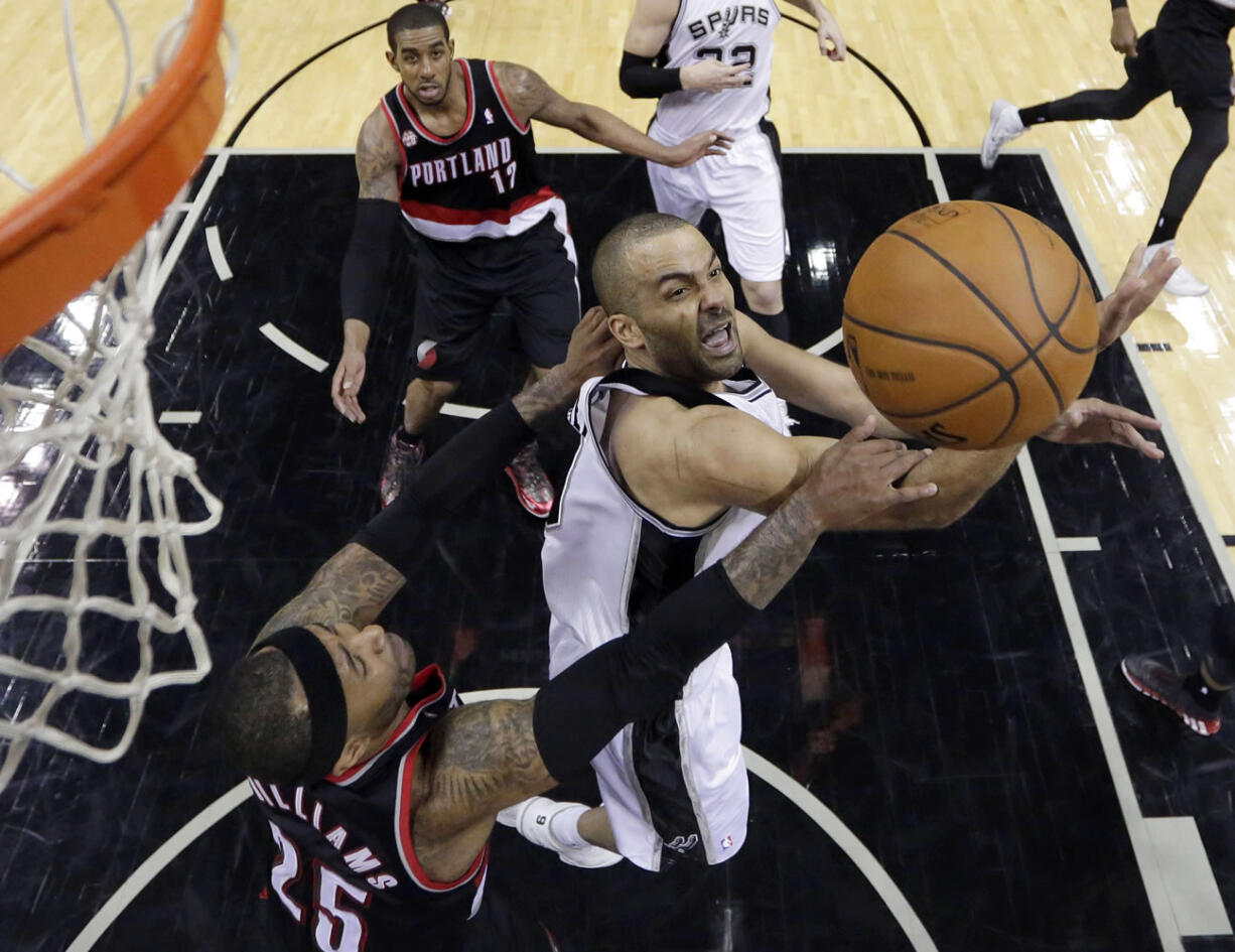 San Antonio Spurs' Tony Parker, right is fouled by Portland's Mo Williams (25) as he drives to the basket during the second half of Game 1 of a Western Conference semifinal NBA basketball playoff series, Tuesday.