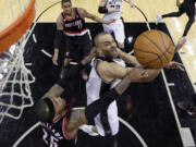 San Antonio Spurs' Tony Parker, right is fouled by Portland's Mo Williams (25) as he drives to the basket during the second half of Game 1 of a Western Conference semifinal NBA basketball playoff series, Tuesday.