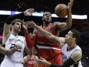 Portland Trail Blazers' LaMarcus Aldridge, center, vies with San Antonio Spurs' Tiago Splitter (22) and Danny Green, right, for a rebound during the first half of Game 5 Wednesday in San Antonio.