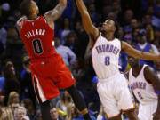 Portland Trail Blazers guard Damian Lillard shoots over Oklahoma City Thunder guard Ish Smith defends during the fourth quarter in Oklahoma City, Tuesday.