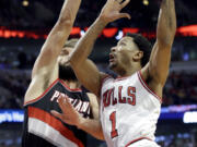 Chicago Bulls guard Derrick Rose (1) drives to the basket against Portland Trail Blazers center Robin Lopez (42) during the second half in Chicago on Friday, Dec. 12, 2014. The Bulls won 115-106. (AP Photo/Nam Y.