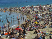 People relax on the beach on July 17 in Barcelona, Spain.