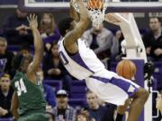 Washington's Shawn Kemp Jr., right, dunks in front of Tulane's Tre Drye during the first half Monday, Dec. 22, 2014, in Seattle.