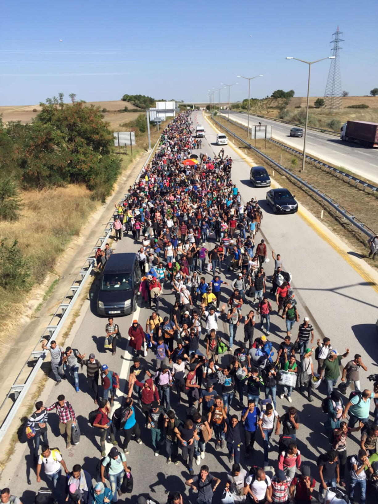 Hundreds of migrants, mostly Syrians, trying to reach Europe, march down a highway toward Turkey&iacute;s western border with Greece and Bulgaria, near Edirne, Turkey, on Friday. They were stopped by Turkish law enforcement before they reached the city center. The migrants have been waiting for days, sleeping in fields and bushes in the northwestern province of Edirne, for Turkey to let them try to cross into Europe.