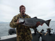 Tyler Martin of Gresham, Ore., holds one of the almost 27,000 fall chinook salmon caught this summer at Buoy 10 at the mouth of the Columbia River.