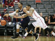 UC Davis' Corey Hawkins (3) and Washington State's DaVonte Lacy reach for a loose ball during the first half Sunday in Pullman.