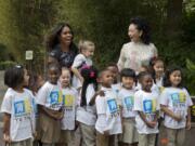 First lady Michelle Obama and China&#039;s first lady Peng Liyuan, are greeted by third graders from Yu Ying Public Charter School in Washington, during a visit Friday to the Smithsonian&#039;s National Zoo in Washington.