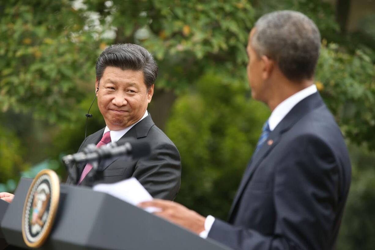 President Xi Jinping looks toward President Barack Obama during their joint news conference in the Rose Garden of the White House in Washington, Friday, Sept. 25, 2015.