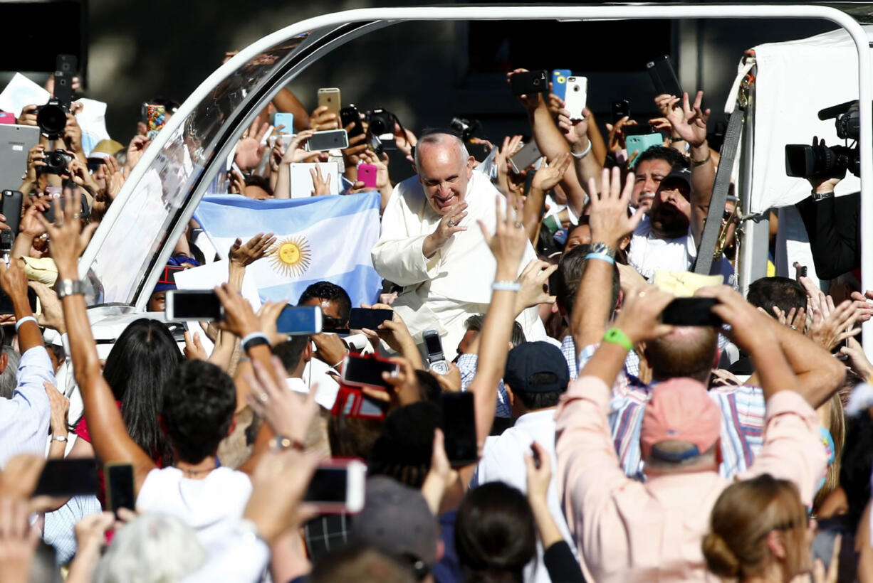 Pope Francis arrives in the popemobile at the Basilica of the National Shrine of the Immaculate Conception in Washington, Wednesday, Sept. 23, 2015, for the Canonization Mass for Junipero Serra.