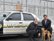 Lt. Thomas Chabot, from left, Sheriff Lew Evangelidis and the department's service dog Nikita, at the Worcester County Jail & House of Correction in West Boylston, Mass. Nikita, the mutt from a Massachusetts animal shelter who got a new life as a K-9 drug-detection dog, stars in an upcoming episode of a new PBS series called "Shelter Me: Partners for Life." The Worcester County sheriff's department in central Massachusetts turned to the shelter for help when there wasn't enough money in the budget to replace its retiring tracking dogs.