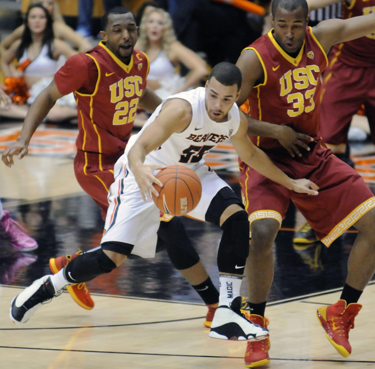 Southern California's Bryon Wesley (22) and DJ Haley (33) defend a drive by Oregon State's Roberto Nelson (55) during the first half Thursday.