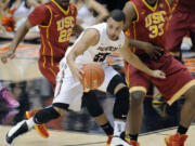 Southern California's Bryon Wesley (22) and DJ Haley (33) defend a drive by Oregon State's Roberto Nelson (55) during the first half Thursday.