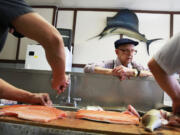 Robert's Fish Market worker Robert Schuffler, 97, watches Luis Fernandez, 58, left, and owner Arturo Venegas, 44, prepare fish at the fish market on West Devon Avenue in Chicago on Friday, April 11, 2014. Chicago-area fish suppliers are dealing with panicked cooks after a shortage of whitefish has left many scrambling to prepare the traditional, if  sometimes dreaded, gefilte fish for Passover, which begins Monday evening.