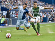 Sporting Kansas City forward Dom Dwyer (14) draws a penalty from Portland Timbers defender Norberto Paparatto (23) during the first half of a U.S.