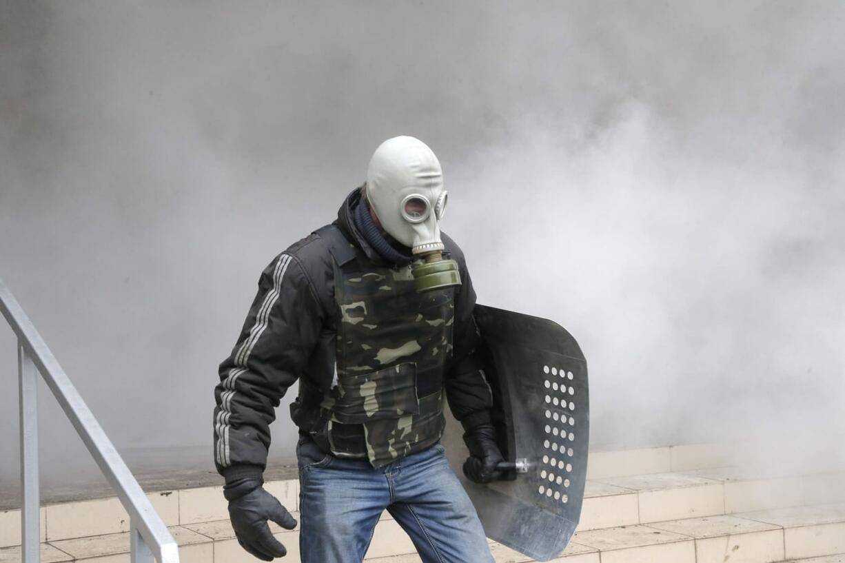 A Pro-Russian activist stands during the mass storming of a police station in the eastern Ukrainian town of Horlivka on Monday.